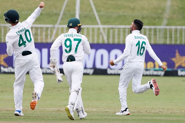 South Africa's Keshav Maharaj (R) celebrates after the dismissal of Bangladesh's Litton Das (not seen) during the fifth day of the first Test cricket match between South Africa and Bangladesh at the Kingsmead stadium in Durban on 4 April 2022