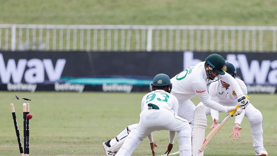 Bangladesh's Yasir Ali (2nd R) is is bowled by South Africa's Keshav Maharaj (not seen) during the fifth day of the first Test cricket match between South Africa and Bangladesh at the Kingsmead stadium in Durban on 4 April, 2022 