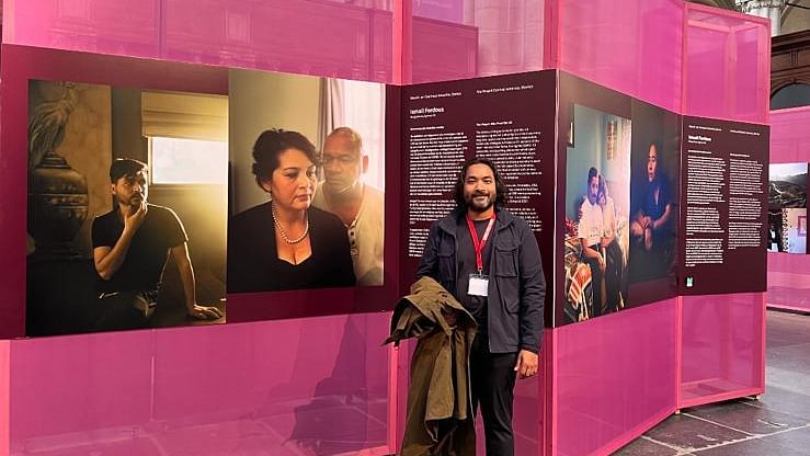 Ismail Ferdous in front of award-winning photographs 