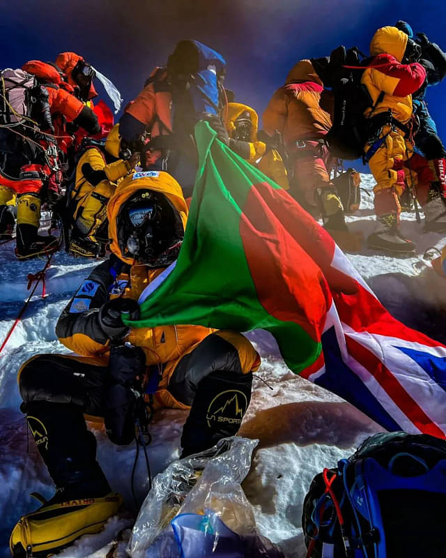 Akke Rahman holding flags of Bangladesh and Uk at the peak of Mount Everest 