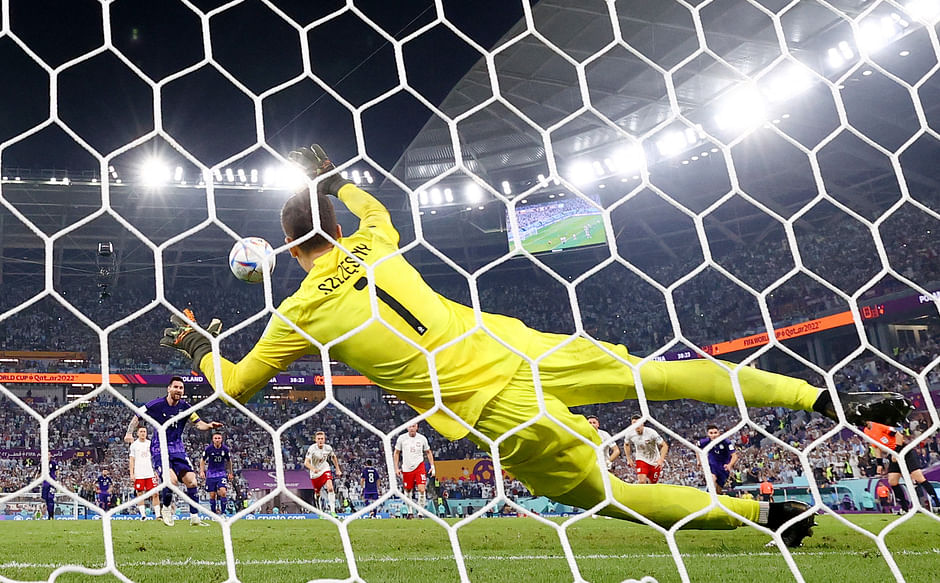 Poland's Wojciech Szczesny saves a penalty from Argentina's Lionel Messi