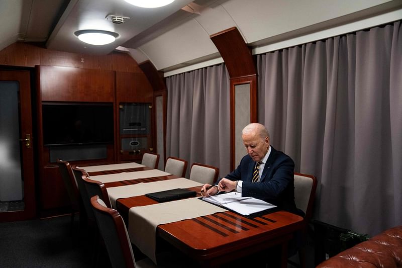 US President Joe Biden checks his watch as he goes over his speech marking the one-year anniversary of the war in Ukraine after a surprise visit to meet with Ukrainian President Volodymyr Zelenskyy, in Kyiv on February 20, 2023