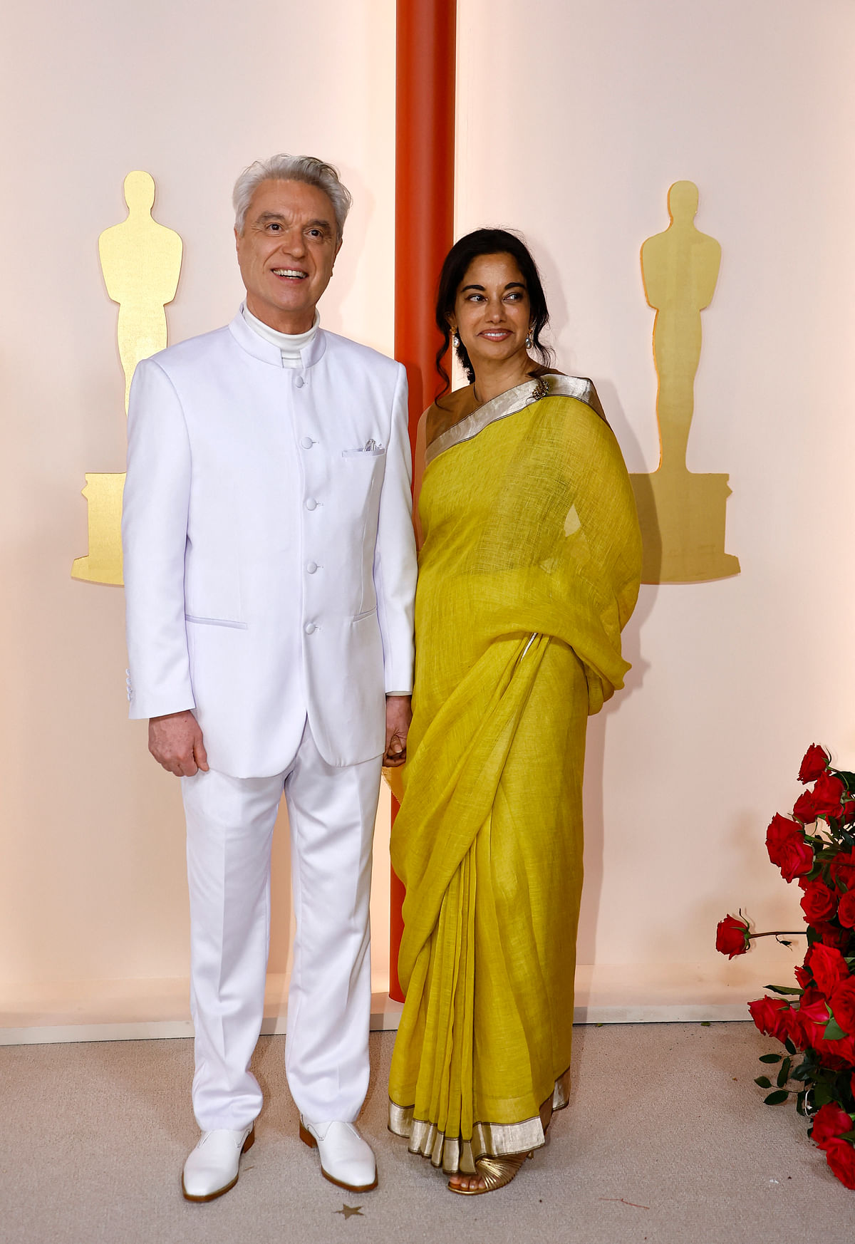 Singer-songwriter David Byrne and guest pose on the champagne-colored red carpet during the Oscars arrivals at the 95th Academy Awards in Hollywood, Los Angeles, California, US, 12 March, 2023. 