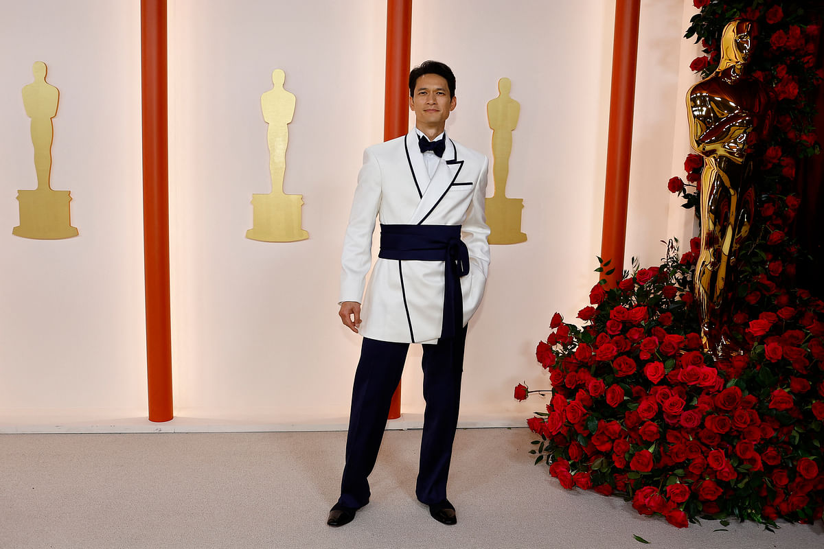 Harry Shum Jr. poses on the champagne-colored red carpet during the Oscars arrivals at the 95th Academy Awards in Hollywood, Los Angeles, California, US, 12 March, 2023. 