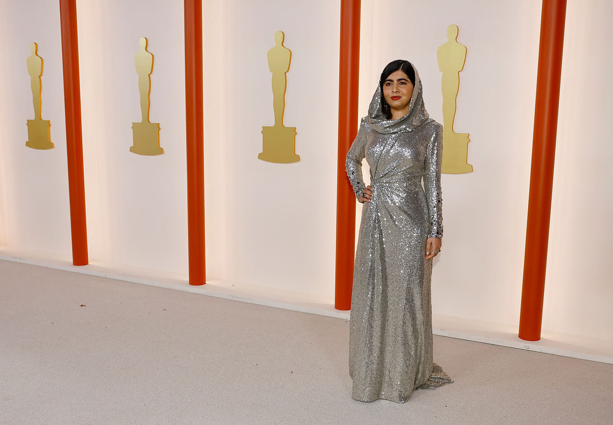 Malala Yousafzai poses on the champagne-colored red carpet during the Oscars arrivals at the 95th Academy Awards in Hollywood, Los Angeles, California, US, 12 March, 2023. 