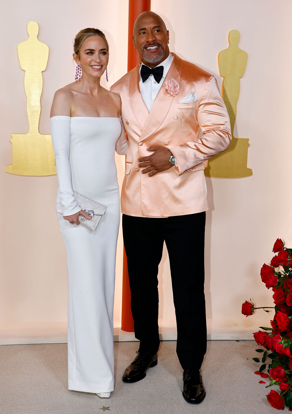 Emily Blunt and Dwayne Johnson pose on the champagne-colored red carpet during the Oscars arrivals at the 95th Academy Awards in Hollywood, Los Angeles, California, US, 12 March, 2023. 