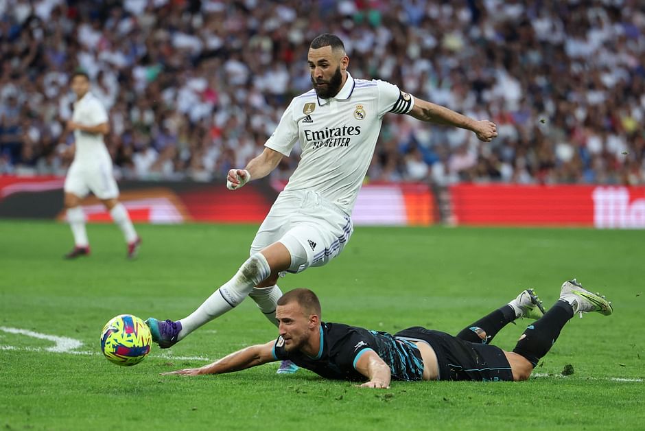 Real Madrid's French forward Karim Benzema vies with Almeria's Brazilian defender Rodrigo Ely in the La Liga match between Real Madrid CF and UD Almeria at the Santiago Bernabeu stadium in Madrid on 29 April 2023