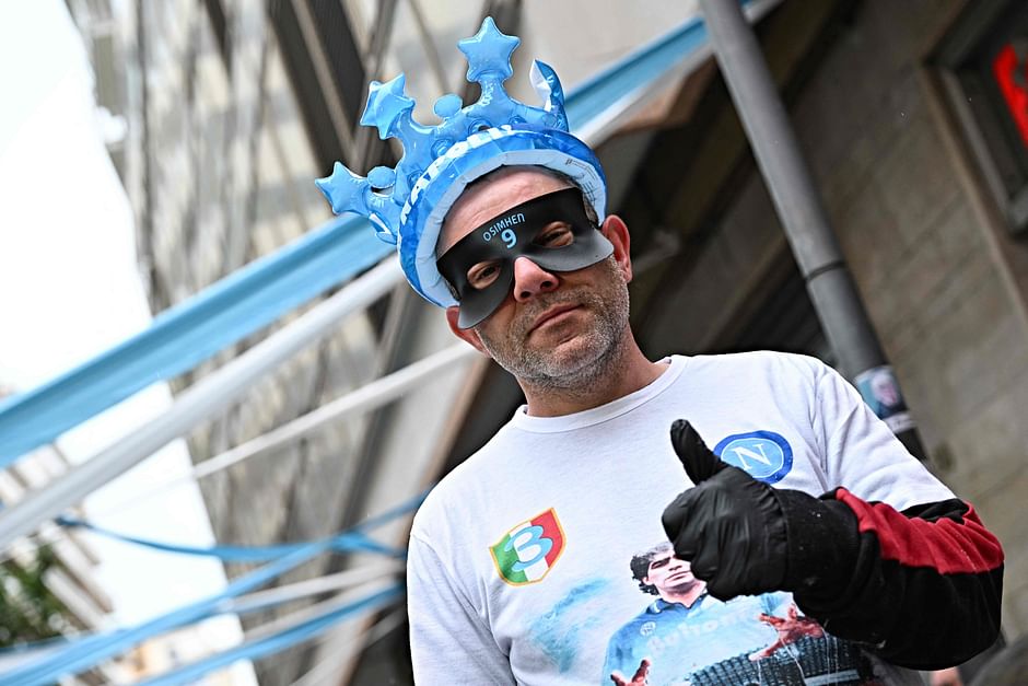  A vendor wearing a mask with the inscription Osimhen in the colors of Napoli, poses for a picture, in Toledo street, in central Naples on 29 April 2023