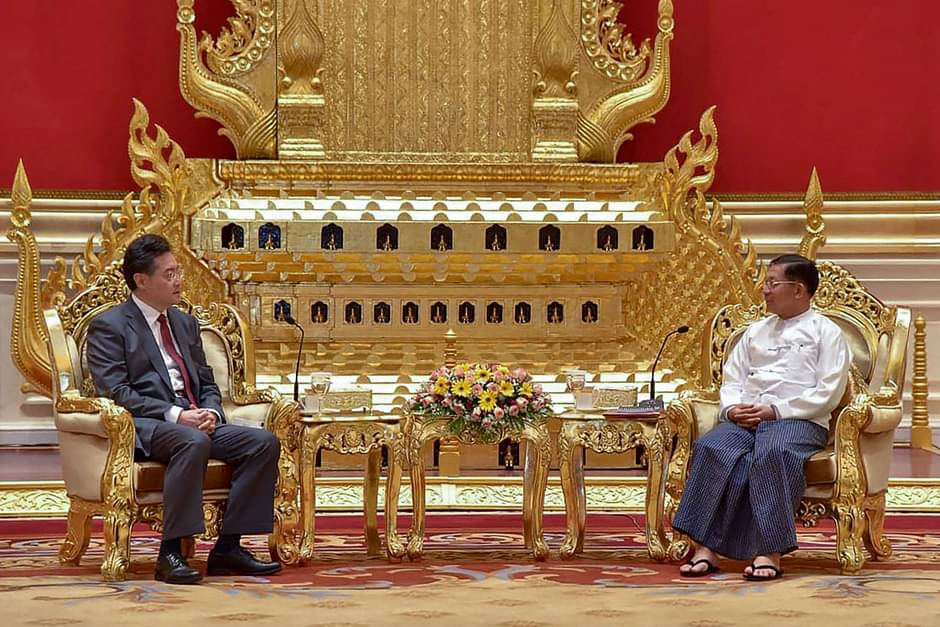 This handout photograph taken and released on 2 May, 2023, by the Myanmar Military Information Team shows Myanmar junta chief Min Aung Hlaing (R) and Chinese Foreign Minister Qin Gang during their meeting in Nay Pyi Taw