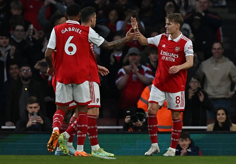 Arsenal's Norwegian midfielder Martin Odegaard (R) celebrates scoring the opening goal during the English Premier League football match between Arsenal and Chelsea at the Emirates Stadium, in London, on 2 May, 2023