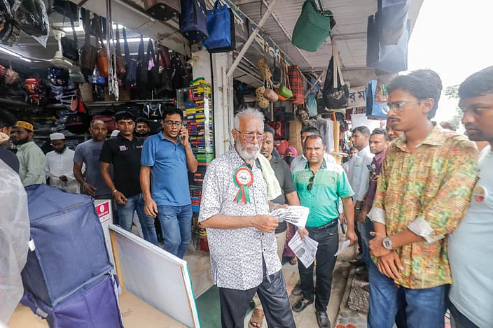 AL mayoral candidate Talukder Abdul Khaleque distributing leaflets among the voters in the Shangkha Market area in Khulna  