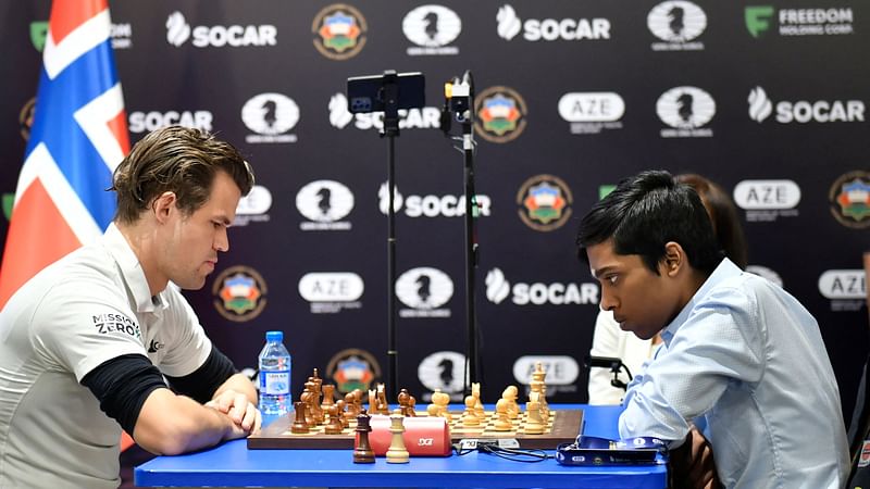 India's Rameshbabu Praggnanandhaa (R) competes against Norway's Magnus Carlsen (L) during the final at the FIDE Chess World Cup in Baku on August 24, 2023