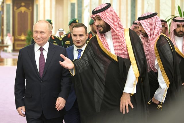 This pool photograph distributed by Russian state agency Sputnik shows Russia's President Vladimir Putin and Saudi Crown Prince Mohammed bin Salman attending a welcoming ceremony ahead of their talks in Riyadh on 6 December, 2023.