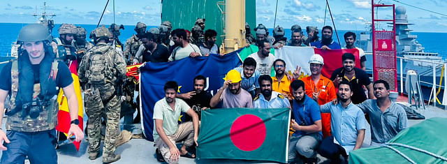 Crewmen on board MV Abdullah pose with flag of Bangladesh after they were released by Somali pirates 