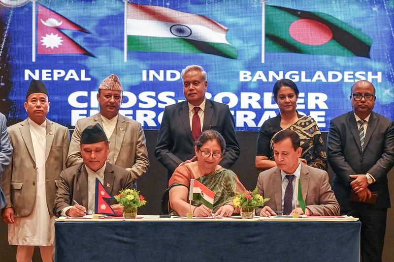 Nepal’s Minister of Energy Deepak Khadka (back, 2L) and Adviser for Environment, Forest and Climate Change of Bangladesh Syeda Rizwana Hasan (back, 2R) look on as Kul Man Ghising (front, L), Managing Director of Nepal Electricity Authority (NEA), signs tripartite power trading deal with India’s NTPC Vidyut Vyapar Nigam Ltd (NVVN) CEO Renu Narang (C) and Bangladesh Power Development Board (BPDB) Chairman Engineer Md Rezaul Karim (front, R) in Kathmandu on 3 October 2024