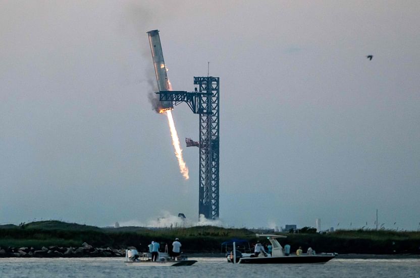 Starship's Super Heavy Booster is grappled at the launch pad in Starbase near Boca Chica, Texas, on 13 October, 2024, during the Starship Flight 5 test. SpaceX successfully "caught" the first-stage booster of its Starship megarocket Sunday as it returned to the launch pad after a test flight, a world first in the company's quest for rapid reusability.