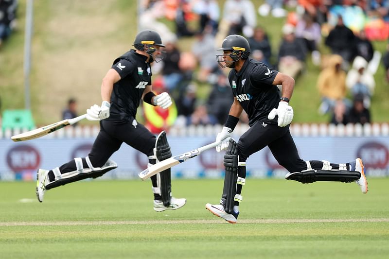 New Zealand's Rachin Ravindra (R) makes a run with teammate Will Young during the first one-day international cricket match between New Zealand and Sri Lanka at the Basin Reserve in Wellington on 5 January, 2025.