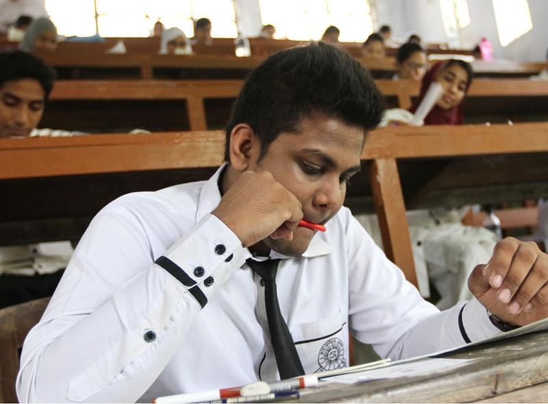 A student is busy with his exam script in Chittagong Govt College. Photo: Saurav Dash