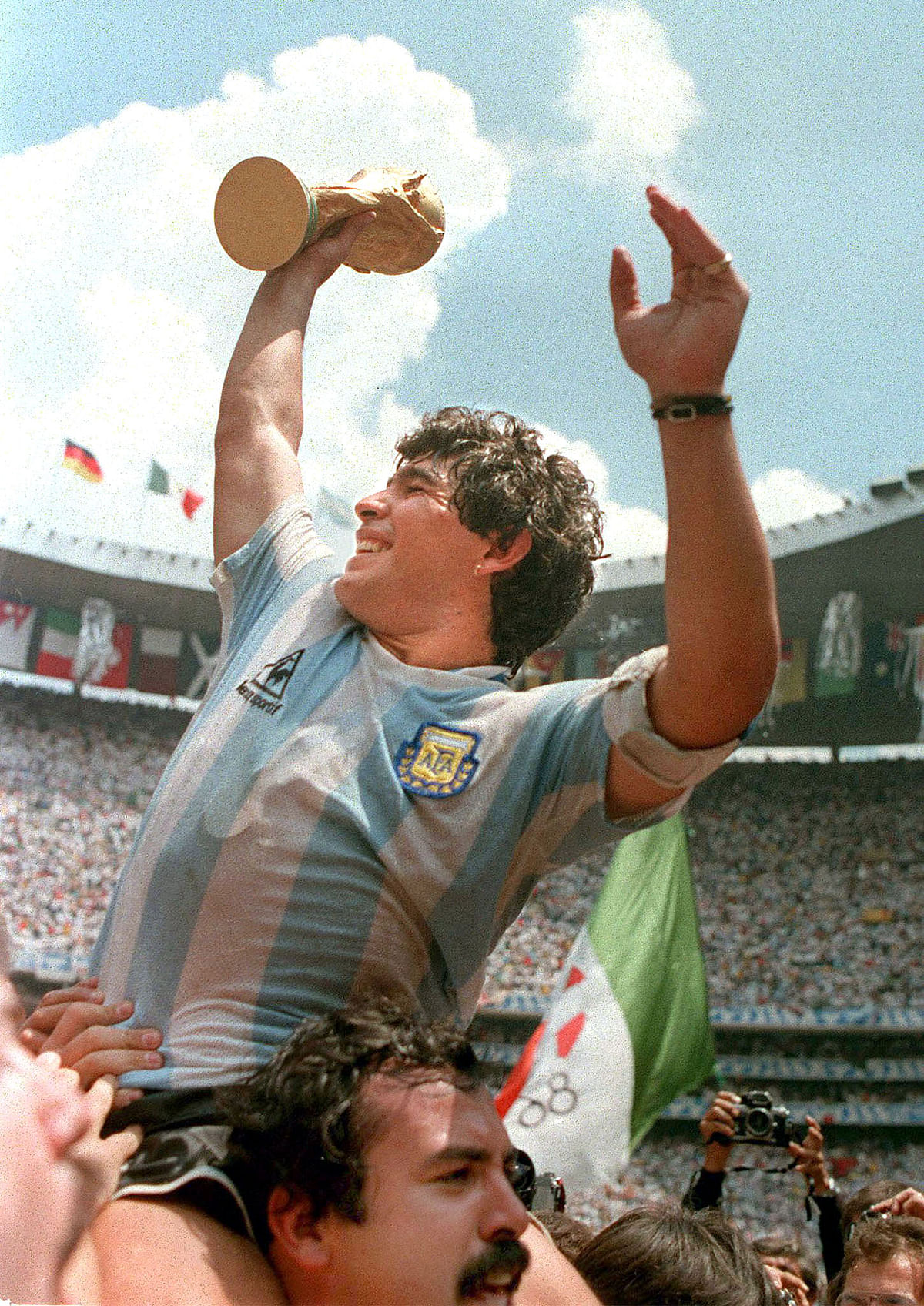Argentina's soccer team captain Diego Maradona brandishes the World Cup trophy after his team beat West Germany 3-2 in the final 29 June 1986 at the Azteca stadium in Mexico City. Photo: AFP