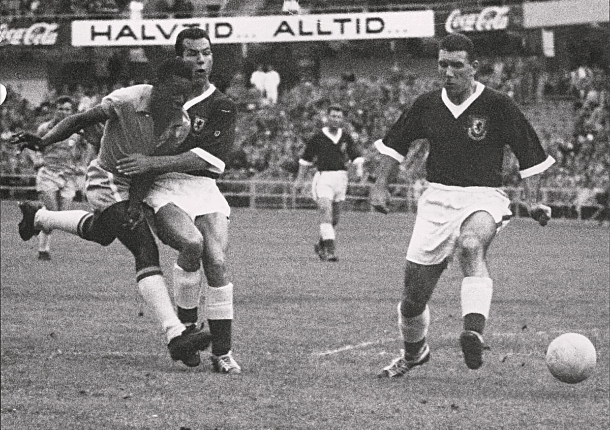 17-year-old Brazilian forward Pele (L) kicks the ball past two Welsh defenders during the World Cup quarterfinal soccer match against Wales on 19 June 1958 in Goteborg. Pele scored the only goal of the match to help Brazil advance to the semifinals. Photo: AFP