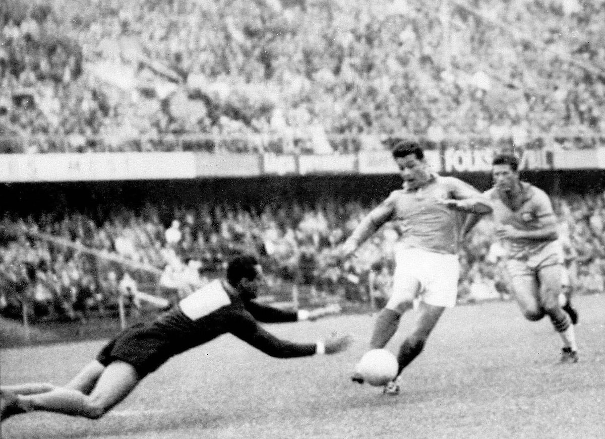 French forward Just Fontaine dribbles past Brazilian goalkeeper Gilmar on his way to score the first goal for his team during the World Cup semifinal match against Brazil on 24 June 1958 at Solna stadium in Stockholm. Brazilian forward Pele scored three times to give Brazil a 5-2 victory over France. Photo: AFP