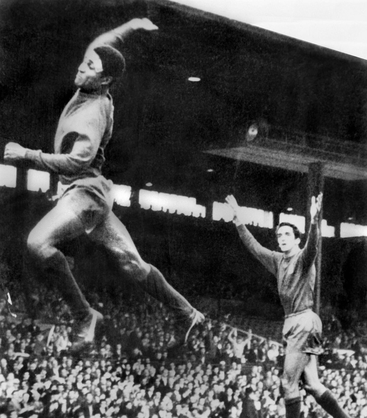 Portuguese forward Eusebio (L) celebrates after scoring a goal during the World Cup first round soccer match against Bulgaria on 17 July 1966 in Manchester. Portugal won 3-0. Photo: AFP