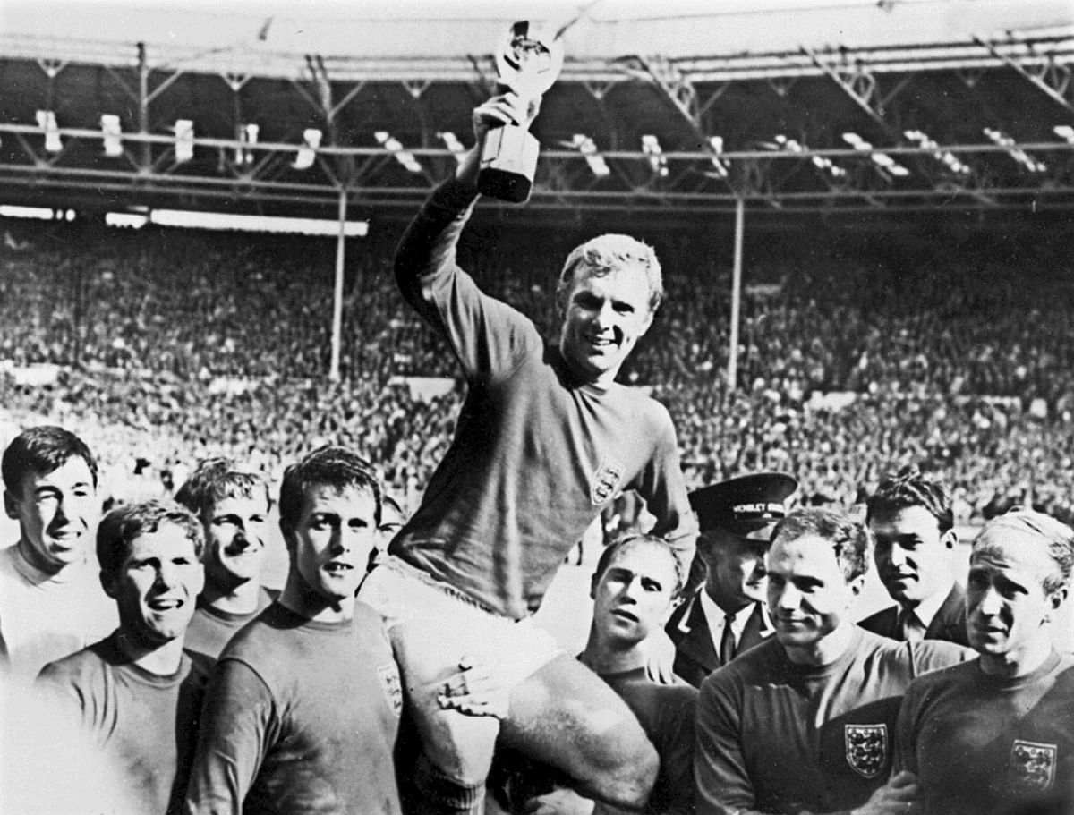 England's national soccer team captain Bobby Moore holds aloft the Jules Rimet trophy as he is carried by his teammates following England's victory over Germany (4-2 in extra time) in the World Cup final 30 July 1966 at Wembley stadium in London. Photo: AFP