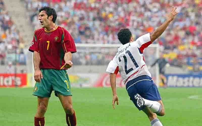 US forward Landon Donovan (R) celebrates after scoring his team's second goal against Portugal in their Group D match at the 2002 FIFA World Cup Korea/Japan in Suwon on 05 June 2002 as Portugal's Luis Figo (L) reacts. The shot by Donavan, deflected off Portugues defender Jorge Costa, was later ruled an own goal. The USA are leading 3-2 in the second half.  Photo: AFP