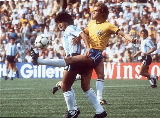 Brazilian midfielder Falcao (R) kicks the ball away from Argentinian forward Diego Maradona during their World Cup second round soccer match on 02 July 1982 in Barcelona. Brazil beat Argentina 3-1. Photo: AFP