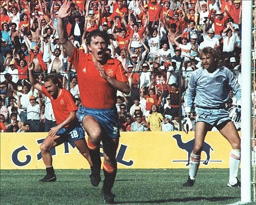 Spanish forward Emilio Butragueno (C) celebrates after scoring a goal past Danish goalkeeper Lars Hogh (R) during the World Cup second round soccer match between Denmark and Spain 18 June 1986 in Queretaro. Butragueno scored four goals as Denmark beat Spain 5-1. Photo: AFP