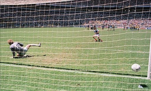 French midfielder Luis Fernandez scores the winning penalty kick in the shootout period as Brazilian goalkeeper Gallo Carlos is caught wrongfooted during the World Cup quarterfinal soccer match between France and Brazil 21 June 1986 in Guadalaraja. France beat Brazil 4-3 on penalty kicks at the end of the extra time period to advance to the semifinals. (The score was 1-1 at the end of regulation). Photo: AFP
