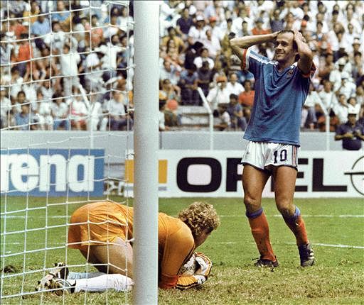 French midfielder Michel Platini reacts after West German goalkeeper Harald Schumacher stopped a shot on 25 June 1986 in Guadalaraja during the World Cup semifinal soccer match between the two countries. West Germany advanced to the final with a 2-0 victory. Photo: AFP