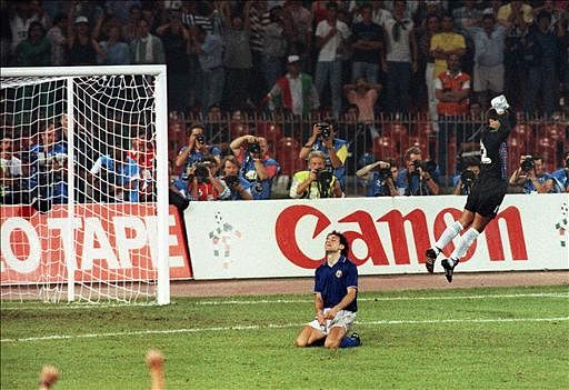 Argentinian goalkeeper Sergio Goycochea celebrates after stopping the penalty kick of Italian Roberto Donadoni (on ground) during the penalty shootout of the World Cup semifinal soccer match between Argentina and Italy on 03 July 1990 in Naples. Argentina advanced to the final with a 4-3 victory on penalty kicks after the two teams were tied at 1 at the end of extra time. Photo: AFP