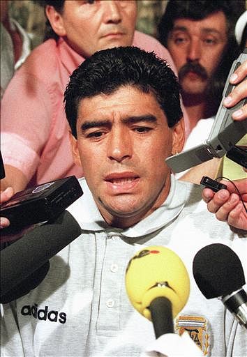 Argentinian midfielder Diego Maradona is surrounded by journalists 30 June 1994 in Dallas, after learning that he tested positive in a drug test following the Soccer World Cup match between Argentina and Nigeria. Maradona was dropped from the Argentinian squad and later expelled from the World Cup by the Federation Internationale de Football Association (FIFA). Photo: AFP