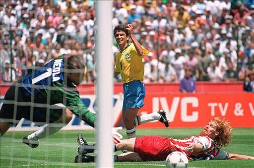 Brazilian forward Bebeto (C) watches his shot go past US defender Alexi Lalas (R) and goalkeeper Tony Meola for a goal during their Soccer World Cup game 04 July 1994 at Sanford stadium in San Francisco. Brazil beat the US 1-0. Photo: AFP
