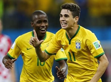 Brazil's Ramires (L) and Brazil's Oscar celebrate during the 2014 World Cup opening match between Brazil and Croatia at the Corinthians arena in Sao Paulo on June 12, 2014. Photo: Reuters