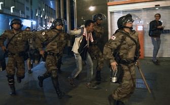 Riot police arrest a man during a demonstration against the FIFA World Cup in Belo Horizonte, Brazil on June 12, 2014. Photo: AFP