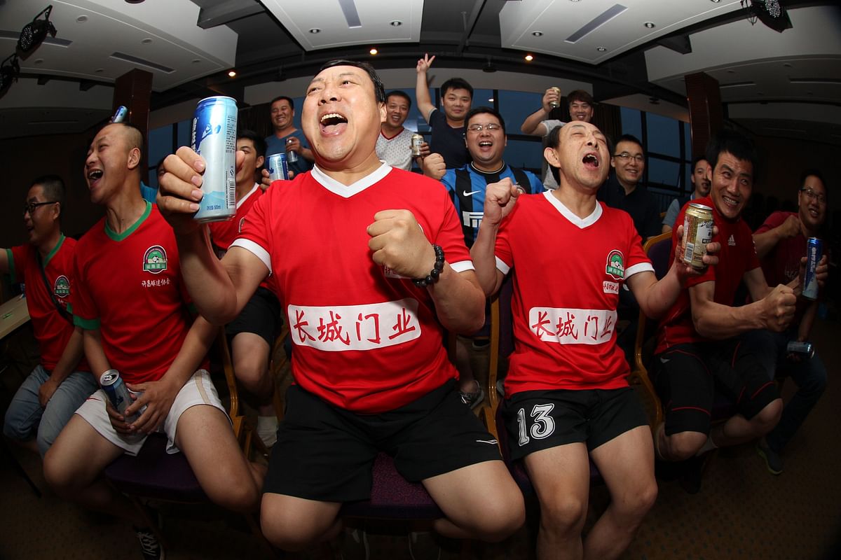 Chinese football fans react as they watch the opening football match between Brazil and Croatia of the 2014 FIFA World Cup, in Xuchang, north China