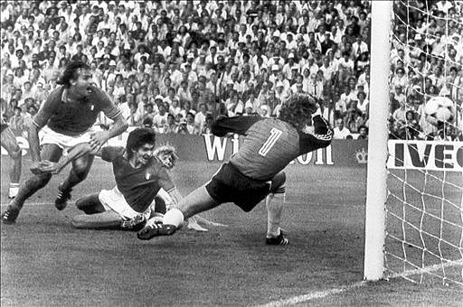 Forward Paolo Rossi (C, on ground) scores Italy's first goal past West German goalkeeper Harald Schumacher as midfielder Antonio Cabrini exults during the World Cup final on 11 July 1982 in Madrid. Italy went on to beat West Germany 3-1. AFP