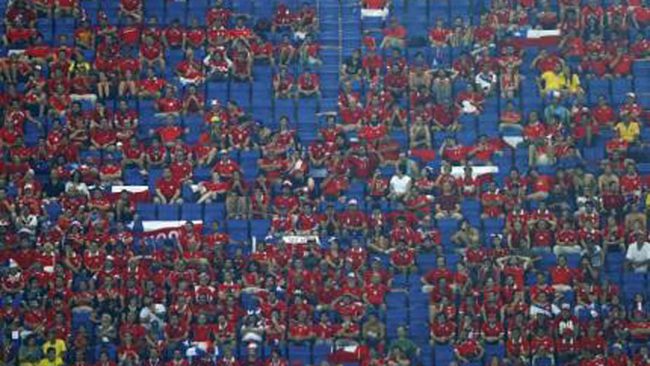 Empty seats are pictured next to spectators during the 2014 World Cup Group B soccer match between Chile and Australia at the Pantanal arena in Cuiaba June 13, 2014. Reuters
