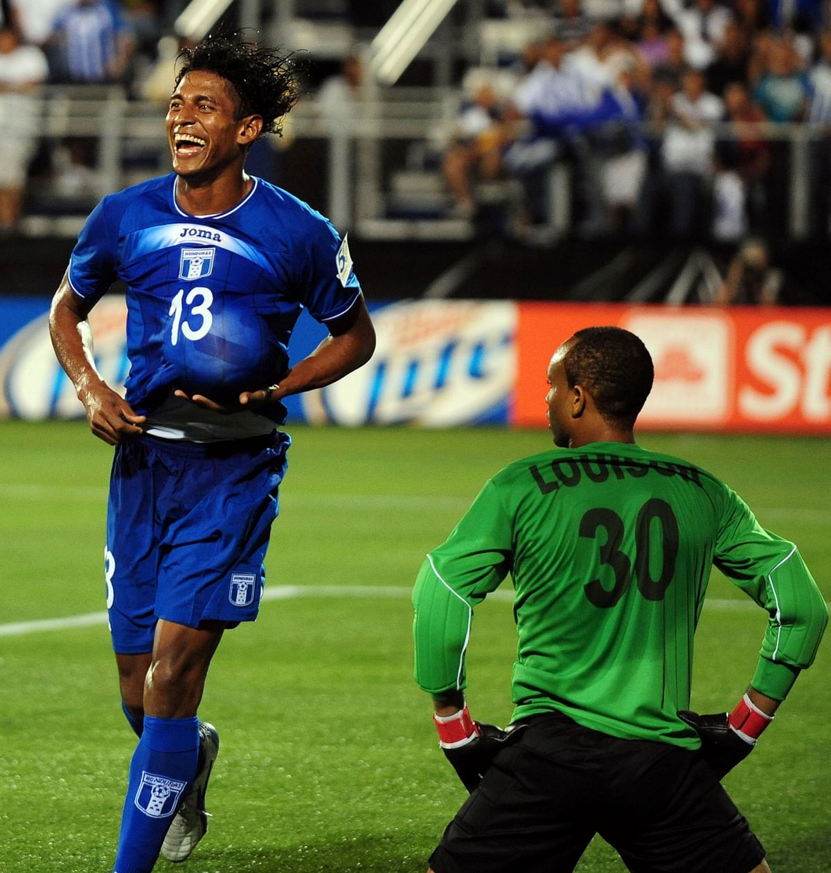 Carlos YaÃ­r Costly (L) of Honduras celebrates a goal before Grenada goalkeeper Shemel Louison (R) during their CONCACAF Gold Cup match at the FIU Stadium in Miami, Florida on June 10, 2011. Honduras defeated Grenada 7-1. AFP
