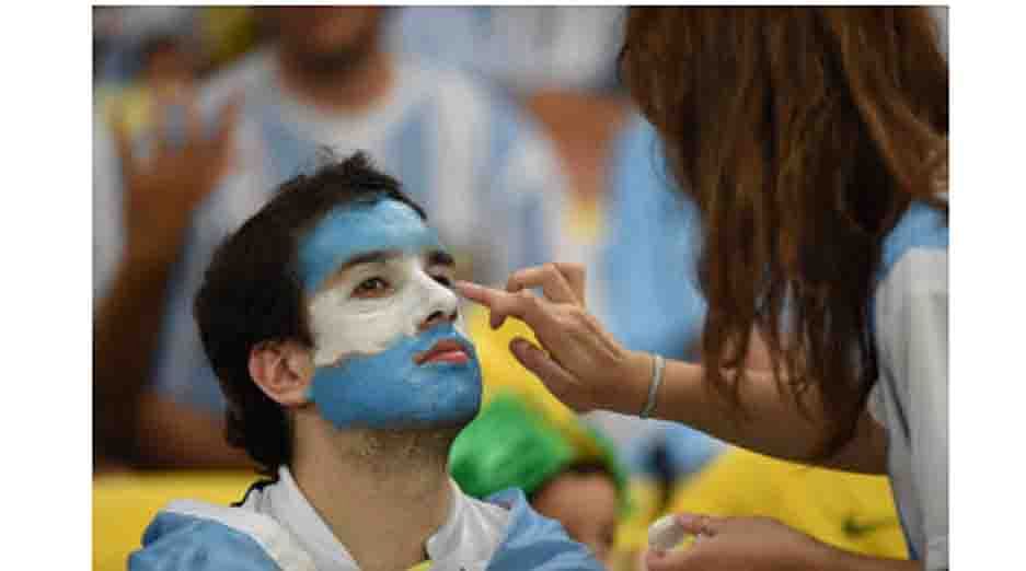 An Argentina fan has his face painted prior to the start of the Group F football match between Argentina and Bosnia-Hercegovina at the Maracana Stadium in Rio De Janeiro during the 2014 FIFA World Cup on June 15, 2014. AFP
