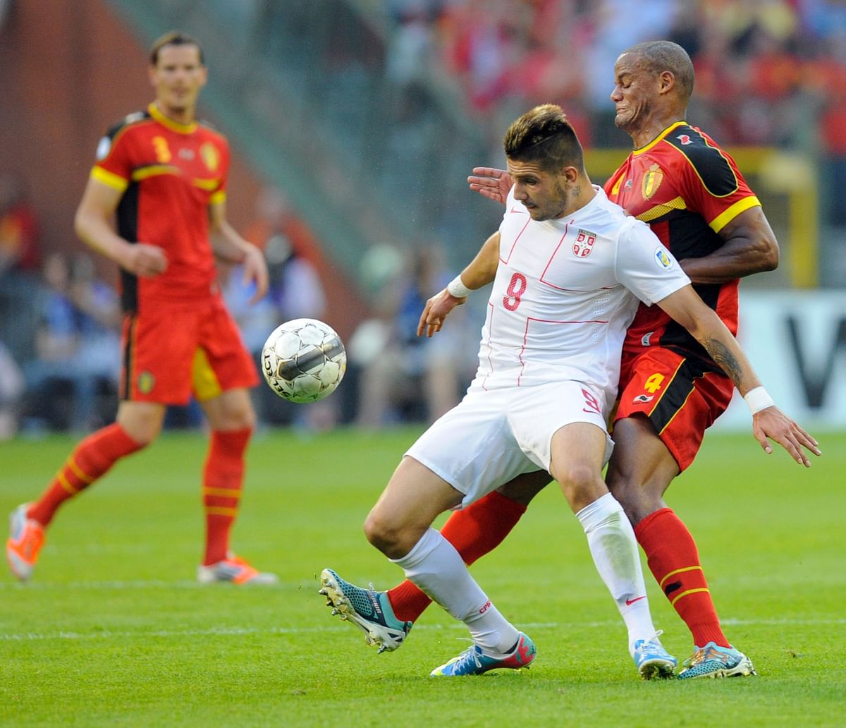 Serbia's forward Aleksandar Mitrovic (2nd L) and Belgium's defender Vincent Kompany (2nd R) vie for the ball during the 2014 World Cup qualifying football match between Belgium and Serbia at the King Baudouin stadium in Brussels on June 7, 2013. AFP