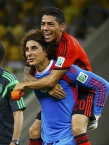 Mexico's goalkeeper Guillermo Ochoa gives teammate Javier Aquino a piggyback ride after their 2014 World Cup Group A soccer match against Brazil in Fortaleza on June 17, 2014. Reuters