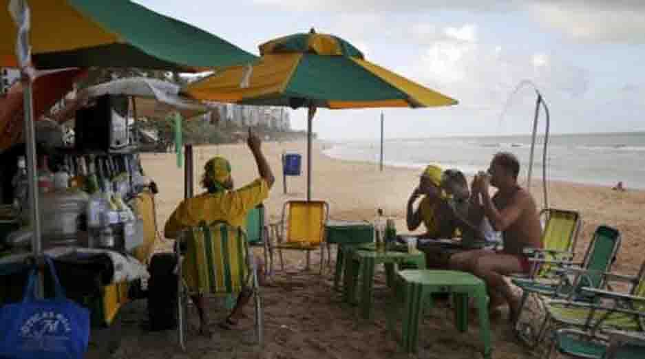 People watch a telecast of the 2014 World Cup Group A match between Brazil and Mexico, on the beach in Recife on June 17, 2014. Reuters