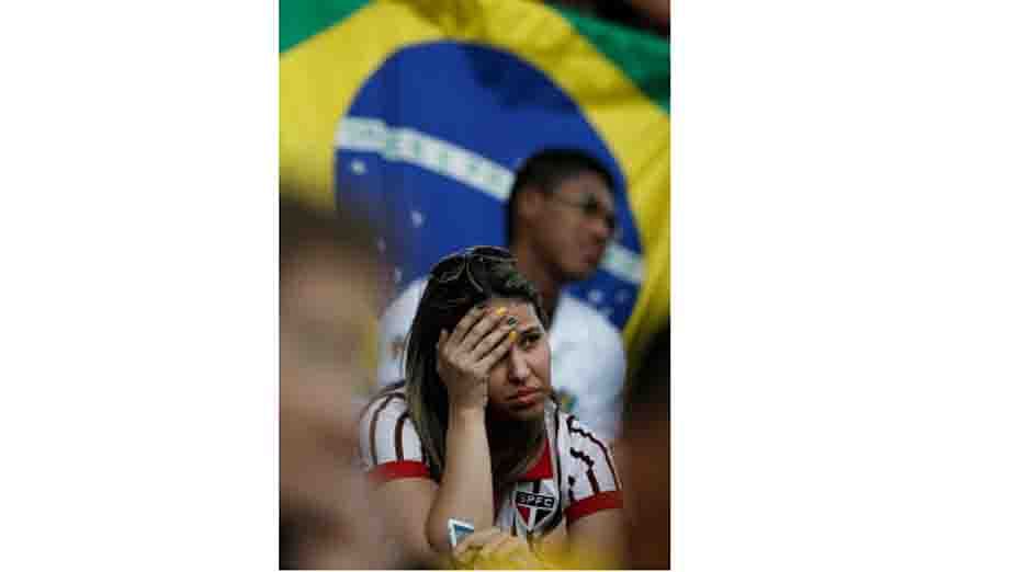 A Brazil fan reacts as she watches the Brazil vs Mexico match on a giant screen prior to the 2014 FIFA World Cup Group H football match between Russia and South Korea in the Pantanal Arena in Cuiaba on June 17, 2014. AFP