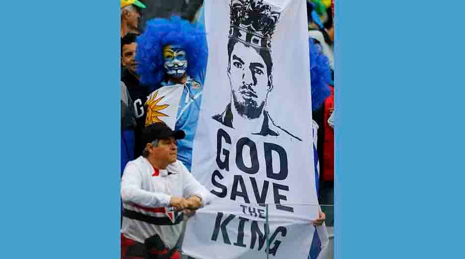 A fan holds up a picture of Uruguay