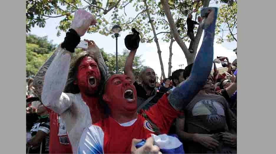 Costa Rican soccer fans celebrate a goal against Italy while watching a large screen broadcasting the 2014 World Cup soccer match between Costa Rica and Italy, at the Democracia square in San Jose on June 20, 2014. Reuters