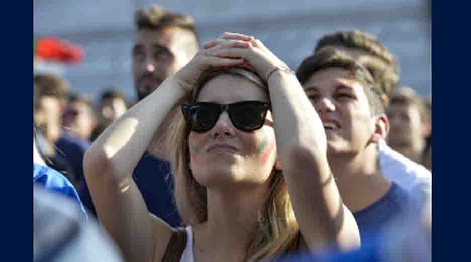 An Italian supporter reacts as she watches on a giant screen the World Cup football match Italy vs Costa Rica on June 20, 2014 on the Piazza Venezia square in Rome. AFP