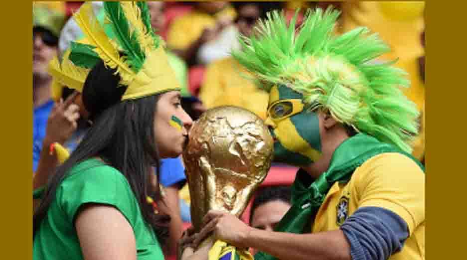 Brazil fans kiss a replica of the World Cup trophy as they cheer prior to the Group A football match between Cameroon and Brazil at the Mane Garrincha National Stadium in Brasilia during the 2014 FIFA World Cup in Brazil on June 23, 2014 AFP